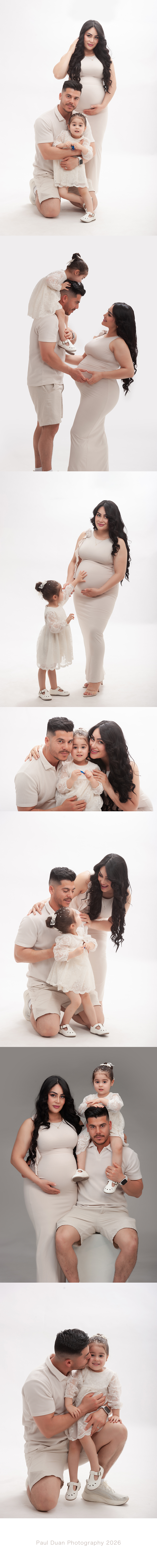 Beautiful family maternity portrait with expecting parents and their little daughter during a pregnancy photoshoot.